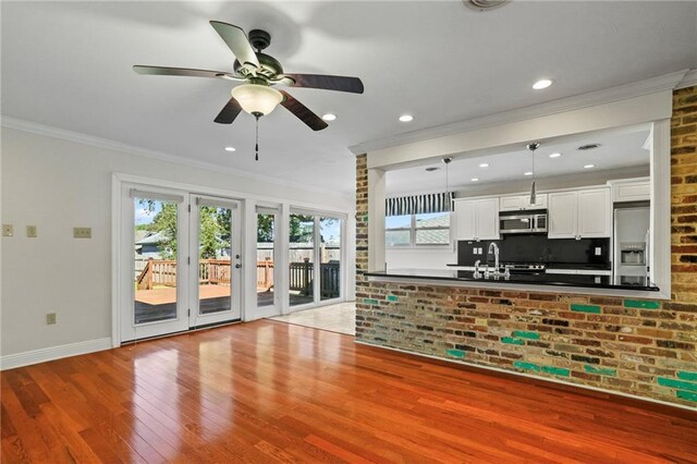 136 Rebel Ave, River Ridge, LA 70123 - unfurnished living room featuring wood finished floors, ornamental molding, baseboards, ceiling fan, and recessed lighting