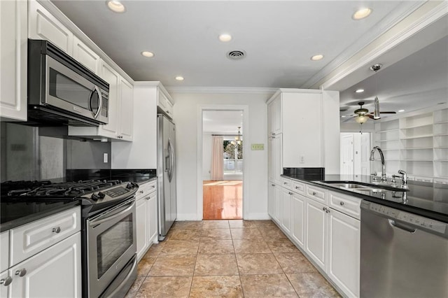 136 Rebel Ave, River Ridge, LA 70123 - kitchen with appliances with stainless steel finishes, a sink, dark countertops, ornamental molding, and recessed lighting