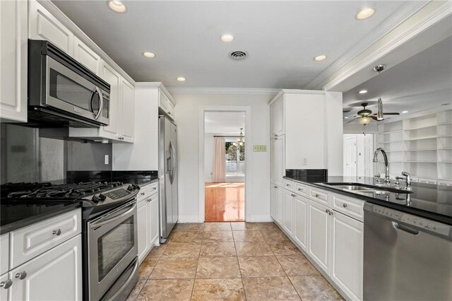136 Rebel Ave, River Ridge, LA 70123 - kitchen with appliances with stainless steel finishes, a sink, dark countertops, ornamental molding, and recessed lighting