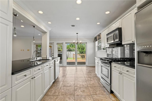 136 Rebel Ave, River Ridge, LA 70123 - kitchen featuring appliances with stainless steel finishes, dark countertops, a sink, crown molding, and white cabinetry