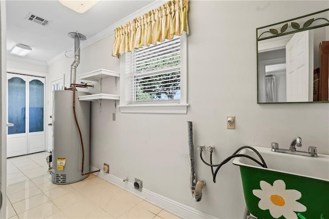 136 Rebel Ave, River Ridge, LA 70123 - washroom featuring gas water heater, ornamental molding, baseboards, and tile patterned floors