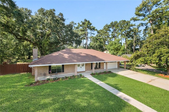 ranch-style home featuring covered porch, a garage, and a front lawn