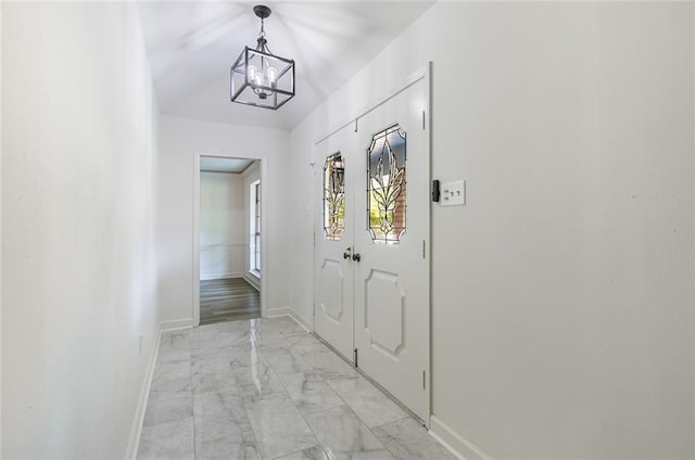 doorway with a notable chandelier