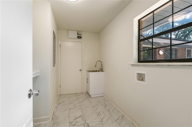 clothes washing area featuring cabinets, washer hookup, and sink