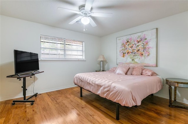 bedroom with ceiling fan and hardwood / wood-style flooring