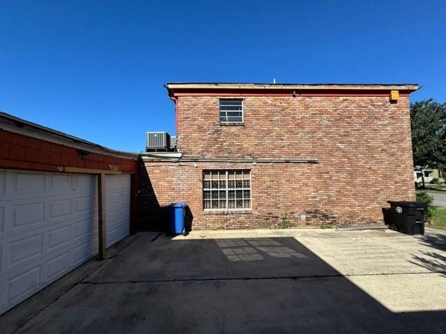 back of property featuring central AC