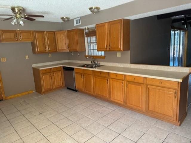 kitchen featuring ceiling fan, dishwasher, light tile patterned floors, and sink