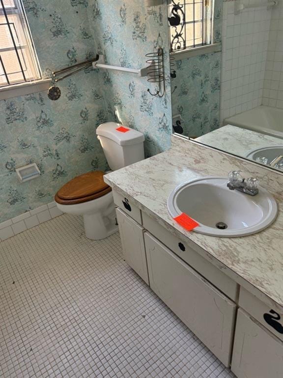 bathroom featuring tile patterned flooring, vanity, and toilet