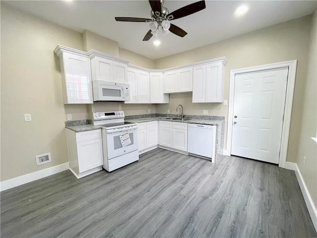 kitchen featuring white cabinets, white appliances, and light hardwood / wood-style flooring