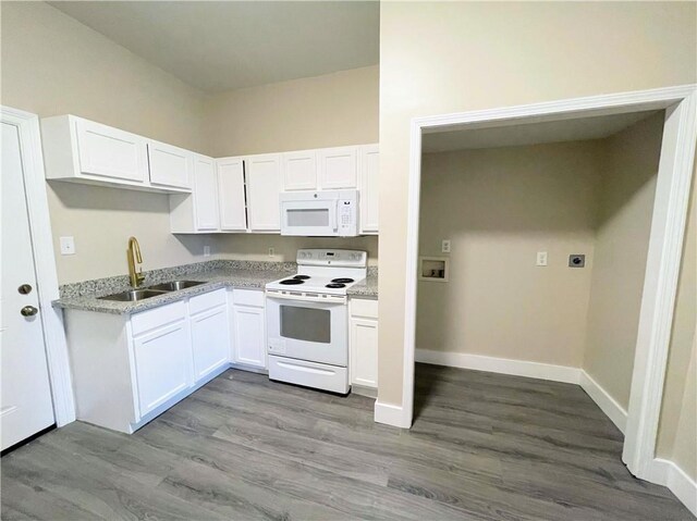 343335 Magnolia St, New Orleans, LA 70115 - kitchen with white appliances, white cabinetry, wood finished floors, and light countertops