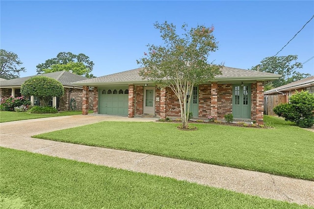 ranch-style home featuring a front yard and a garage