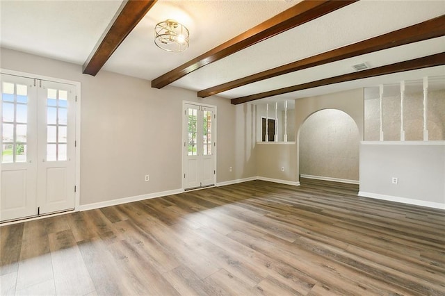 interior space featuring hardwood / wood-style floors, a notable chandelier, and beam ceiling