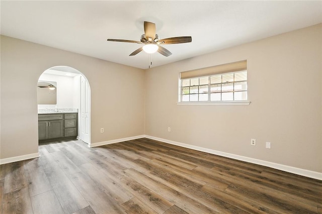 empty room featuring hardwood / wood-style floors and ceiling fan