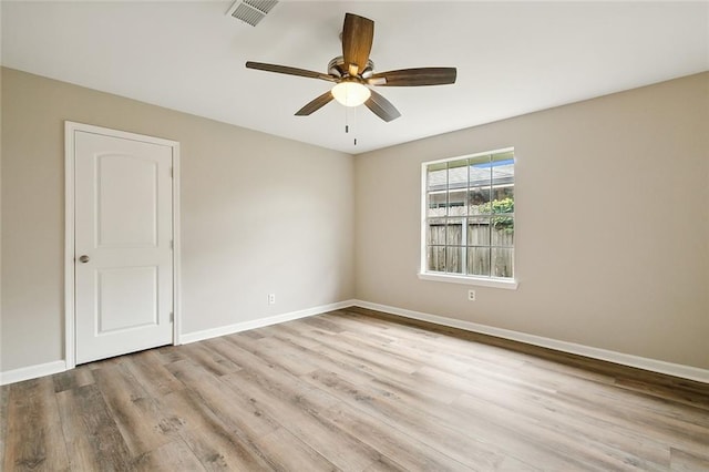 spare room featuring ceiling fan and light hardwood / wood-style floors