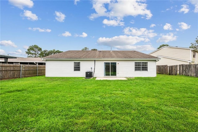 back of property with a lawn and cooling unit