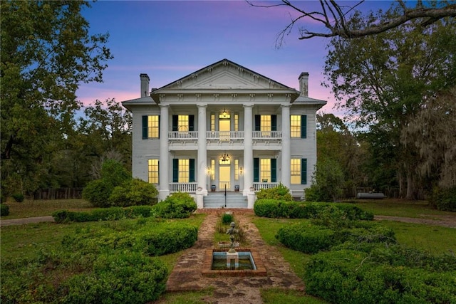 2513 Red Lick Rd, Lorman, MS 39096 - neoclassical home featuring a chimney, a balcony, and a porch