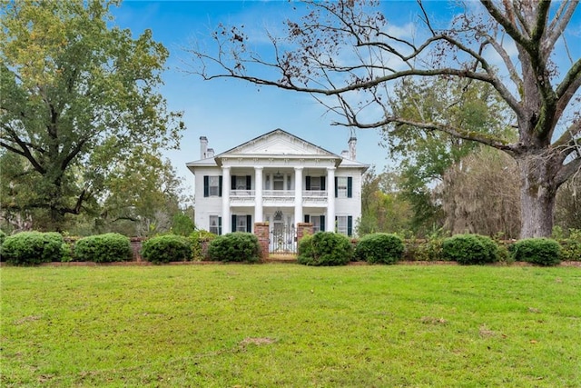 2513 Red Lick Rd, Lorman, MS 39096 - greek revival inspired property featuring a balcony, a front lawn, and a chimney