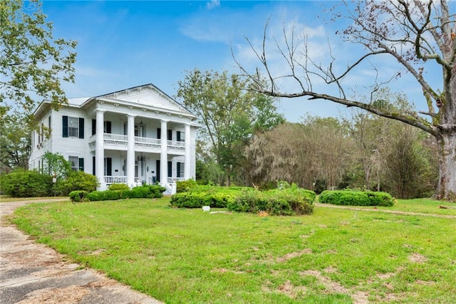 2513 Red Lick Rd, Lorman, MS 39096 - neoclassical home with a balcony, covered porch, and a front lawn