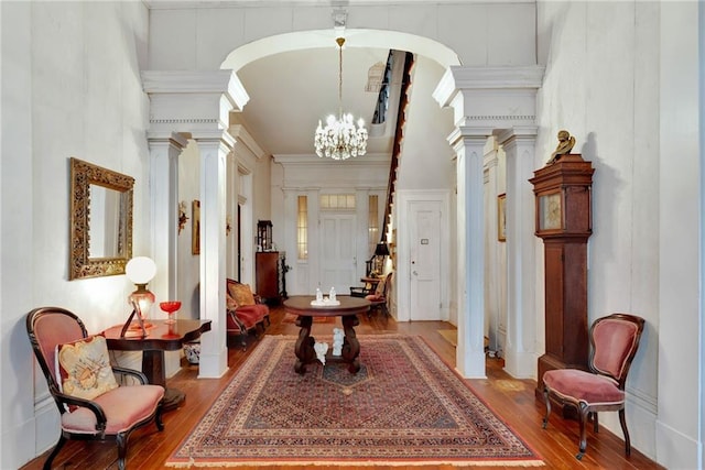 2513 Red Lick Rd, Lorman, MS 39096 - entryway featuring a decorative wall, wood finished floors, decorative columns, a chandelier, and a high ceiling
