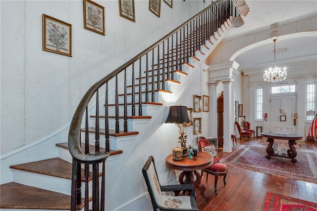 2513 Red Lick Rd, Lorman, MS 39096 - stairway with hardwood / wood-style flooring, ornamental molding, a chandelier, ornate columns, and arched walkways