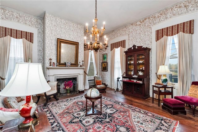 2513 Red Lick Rd, Lorman, MS 39096 - living area featuring ornamental molding, healthy amount of natural light, wallpapered walls, wood finished floors, and a chandelier