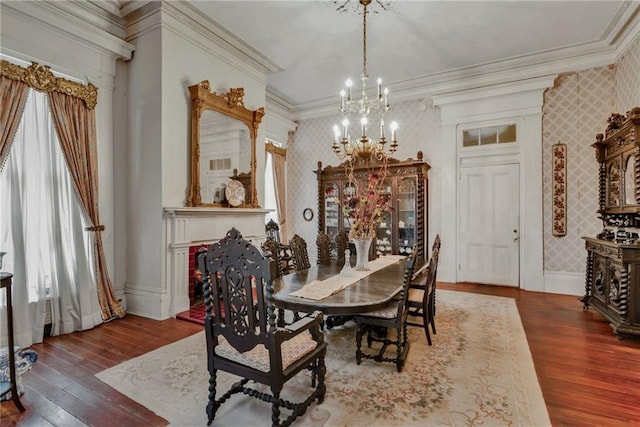 2513 Red Lick Rd, Lorman, MS 39096 - dining room with wallpapered walls, a chandelier, ornamental molding, and wood-type flooring