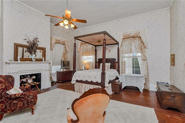 2513 Red Lick Rd, Lorman, MS 39096 - bedroom featuring wallpapered walls, crown molding, wood finished floors, a fireplace, and a ceiling fan