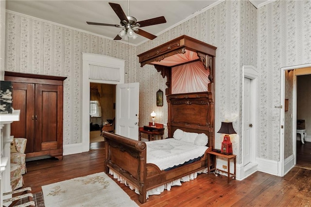 2513 Red Lick Rd, Lorman, MS 39096 - bedroom featuring hardwood / wood-style floors, crown molding, wallpapered walls, a ceiling fan, and a fireplace with raised hearth