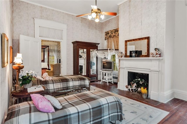 2513 Red Lick Rd, Lorman, MS 39096 - living room with hardwood / wood-style flooring, crown molding, a fireplace with flush hearth, a ceiling fan, and wallpapered walls