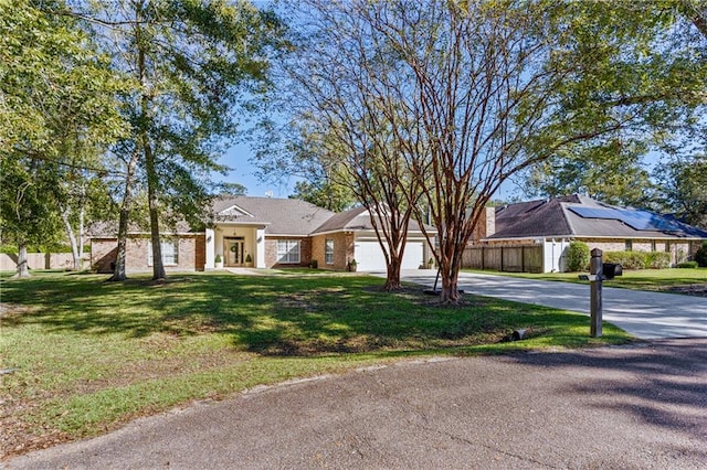 view of front of house featuring a garage and a front lawn