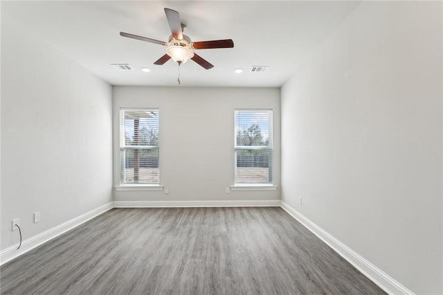 unfurnished room featuring ceiling fan, a healthy amount of sunlight, and wood-type flooring