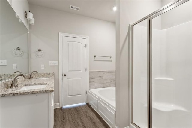 bathroom featuring hardwood / wood-style floors, vanity, and independent shower and bath