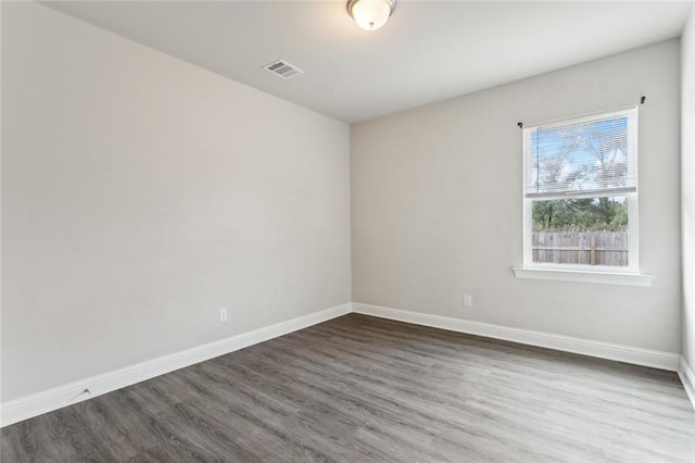 empty room with dark wood-type flooring