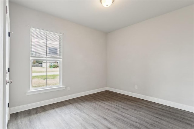 empty room with dark hardwood / wood-style floors