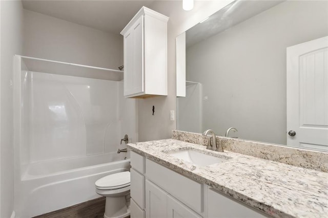 full bathroom with shower / tub combination, hardwood / wood-style flooring, vanity, and toilet