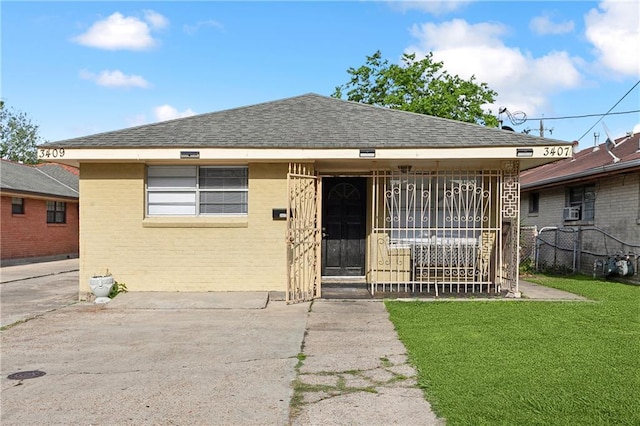 bungalow-style home featuring a front lawn