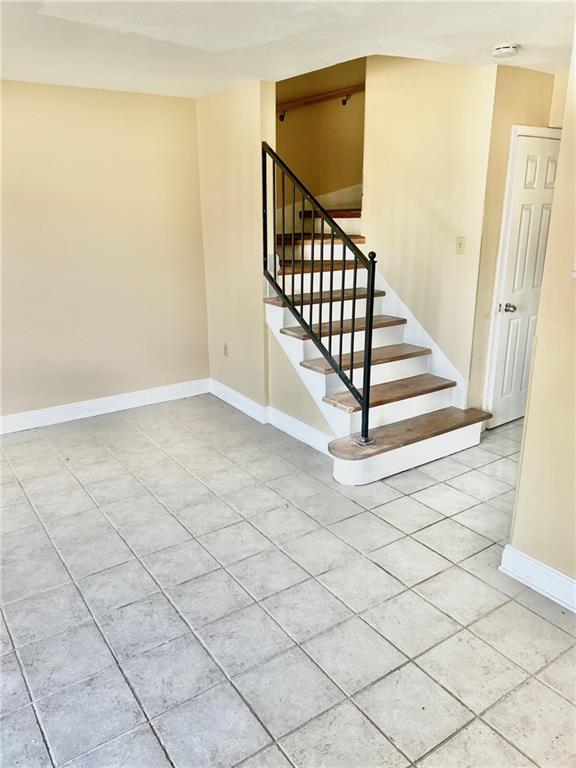 staircase featuring tile patterned floors