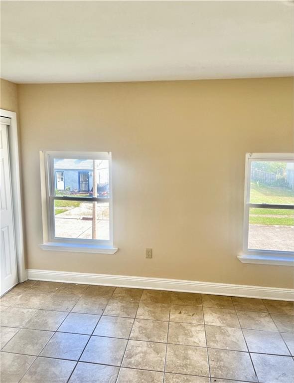 unfurnished room featuring light tile patterned flooring