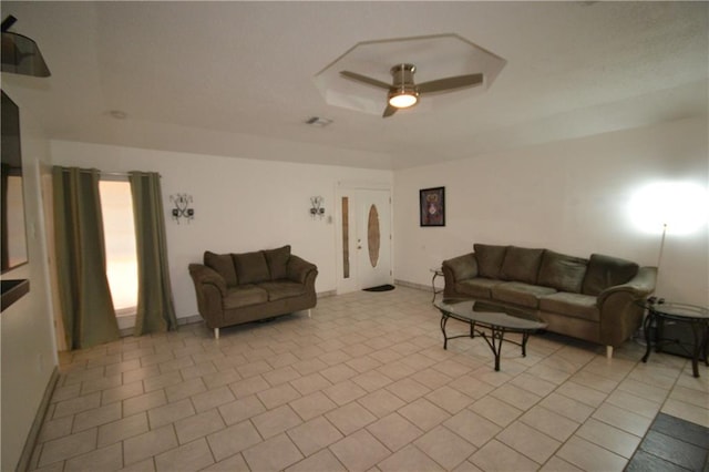 tiled living room with ceiling fan