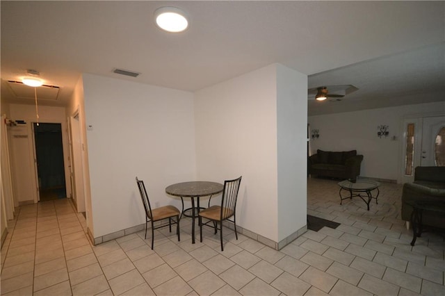 tiled dining area featuring ceiling fan