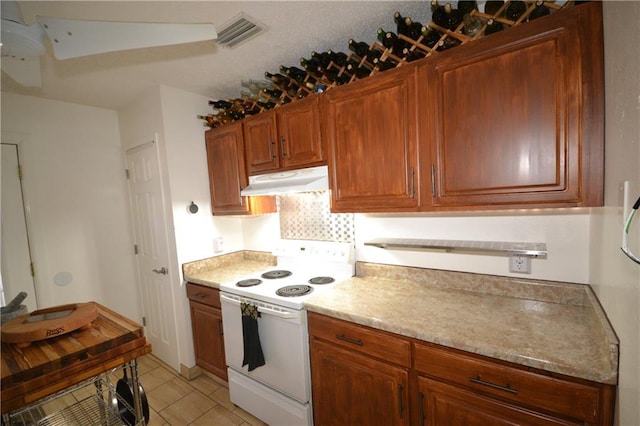 kitchen featuring electric stove and light tile patterned floors