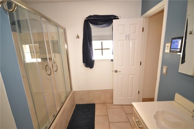 bathroom with tile patterned flooring, vanity, and a shower with shower door