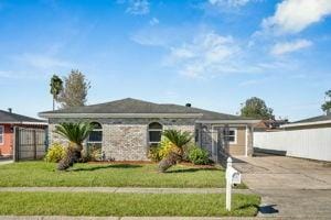 ranch-style home with a garage and a front lawn