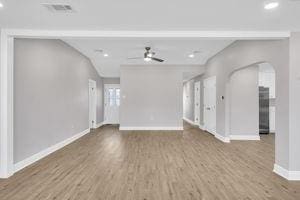 unfurnished living room with hardwood / wood-style flooring and ceiling fan