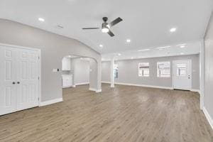 unfurnished living room with ceiling fan, lofted ceiling, and hardwood / wood-style flooring