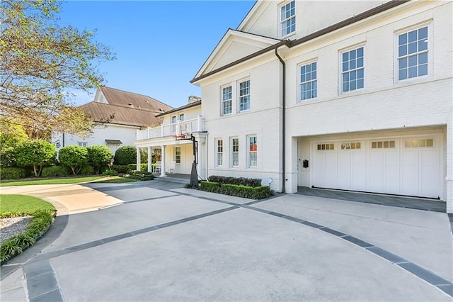 view of front of property with a garage and a balcony