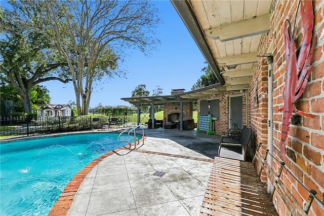 view of pool with pool water feature and a patio