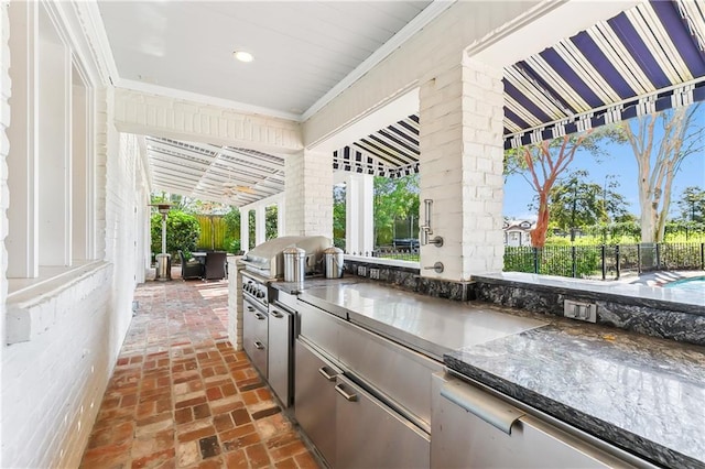 view of patio with area for grilling and a grill