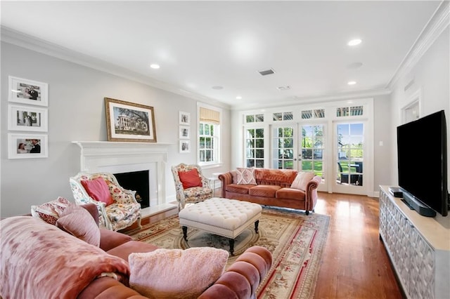 living room with hardwood / wood-style floors, french doors, and ornamental molding