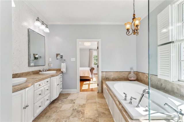 bathroom featuring vanity, an inviting chandelier, a tub, and ornamental molding